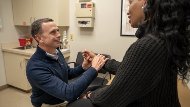 Doctor preforming test on patients wrist